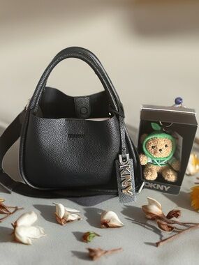 DKNY BLACK PEBBLED LEATHER SHOULDER BAG WITH DKNY TEDDY BEAR CHARM NOT INCLUDED.